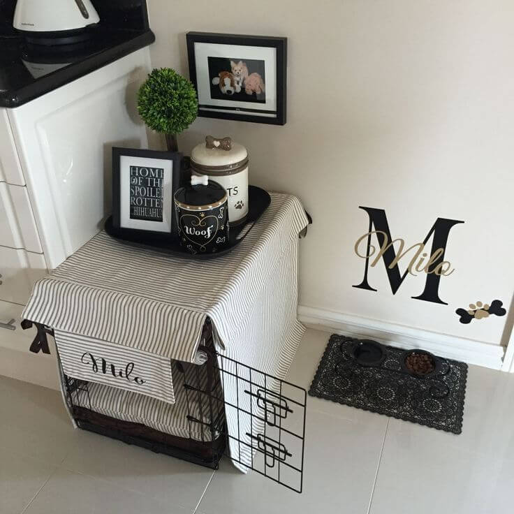 Dog crate adorned with black and white fabric