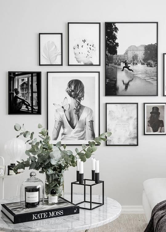 Living room wall with black and white pictures in black frames