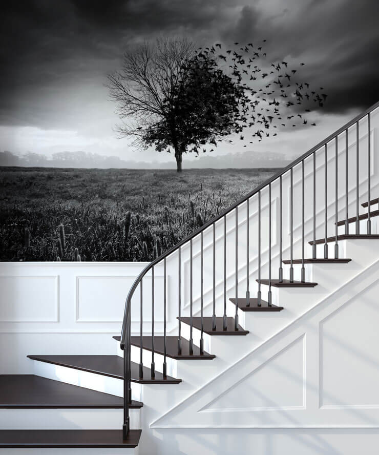 Black and white stair case with a black and white tree mural