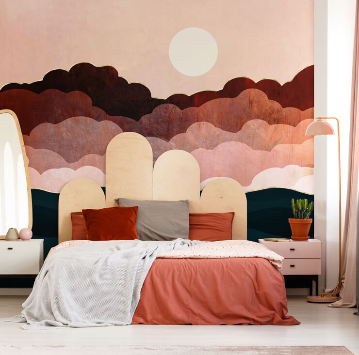 Red and dusty pink wall mural in a bedroom with white and dark orange bedsheets and a wooden headboard