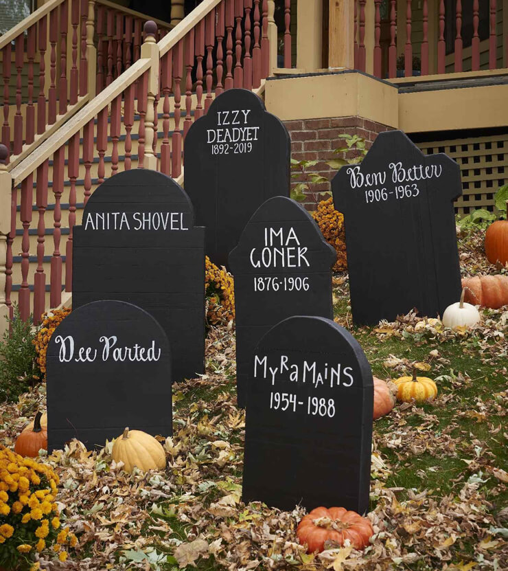 Garden with black, handmade gravestone decorations for Halloween