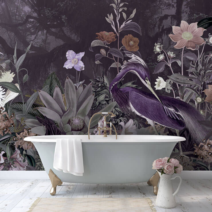 Pastel blue bathtub in a bathroom with a deep purple, floral wallpaper with a large heron