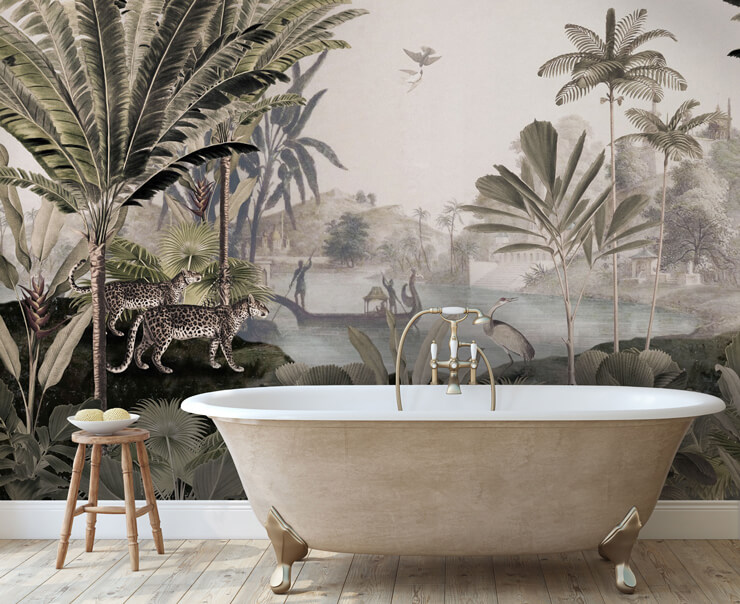 Rose gold bathtub in a bathroom with a muted green and beige jungle wallpaper