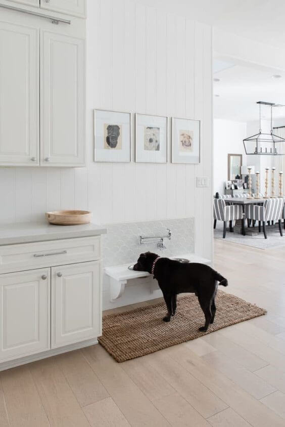 Neutral kitchen with white cubaords and walls with a beige rattan rug