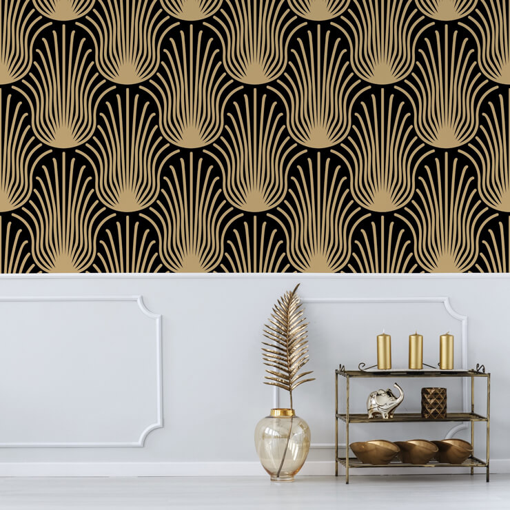 Gold and black wallpaper on a wall with white panels and gold accessories