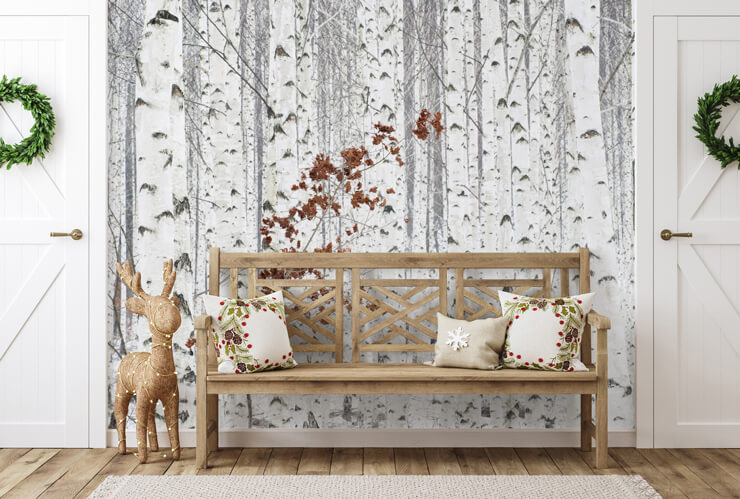 Scandinavian themed hallway with a snowy tree wall mural and wooden bench