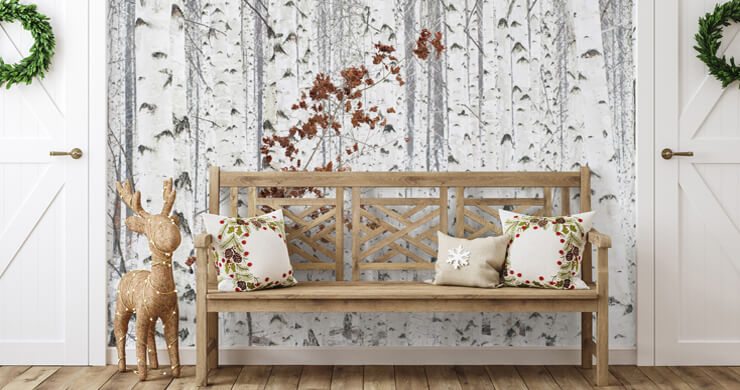 Scandinavian decor theme in a hallway with a wooden bench and snowy forest wallpaper