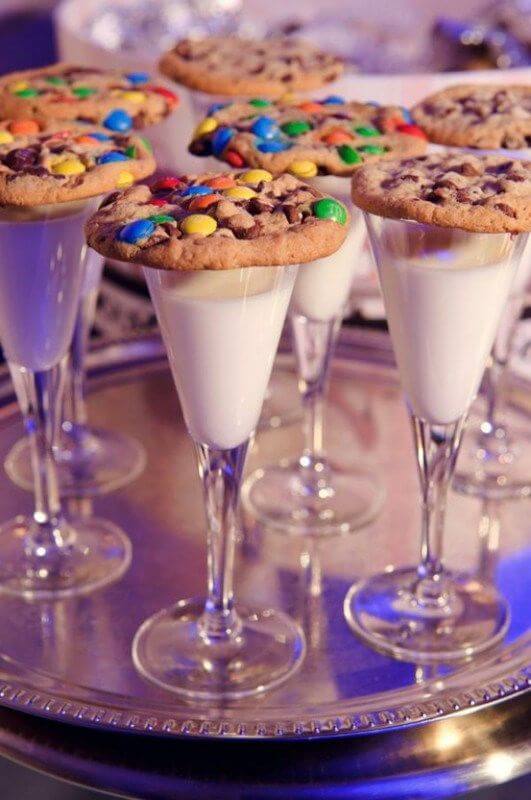 cocktail glasses with milk and smartie cookies for children