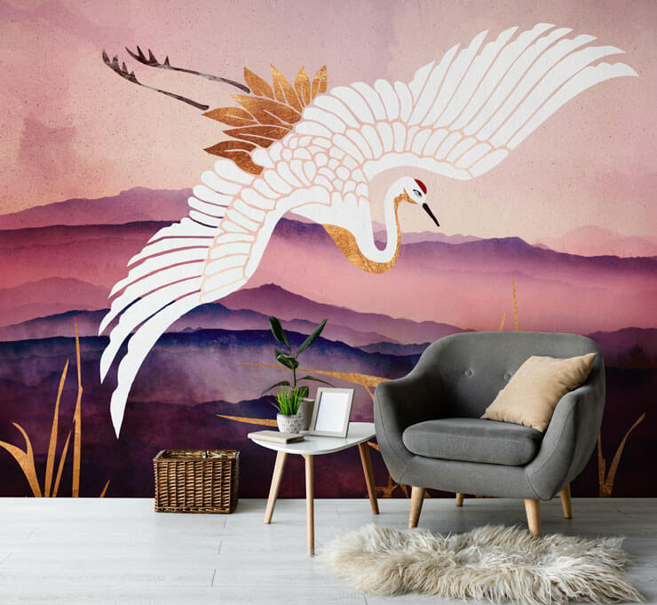 Abstract wallpaper with purple and pink mountains and a flying crane bird with a grey chair and light wooden floor