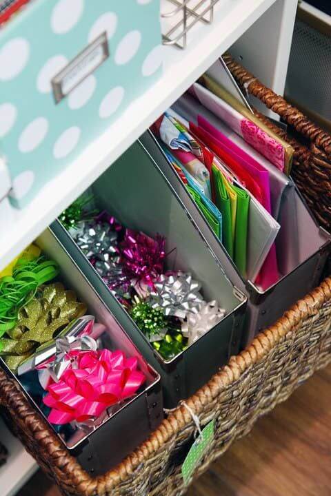 Home office with cardboard file holders filled with wrapping bows and ribbons
