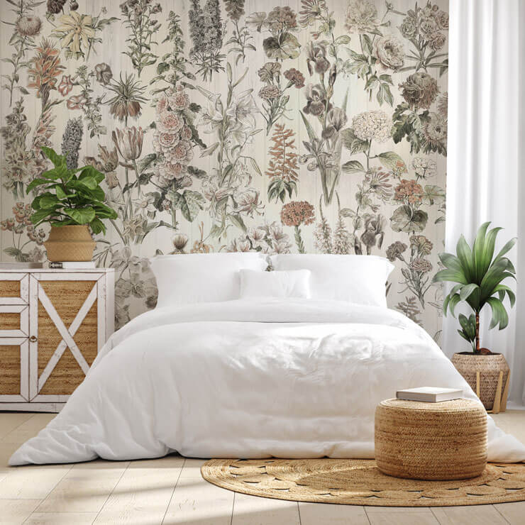 Beige floral wallpaper in a bedroom with white bedsheets, a rattan rug and bedside units with rattan doors