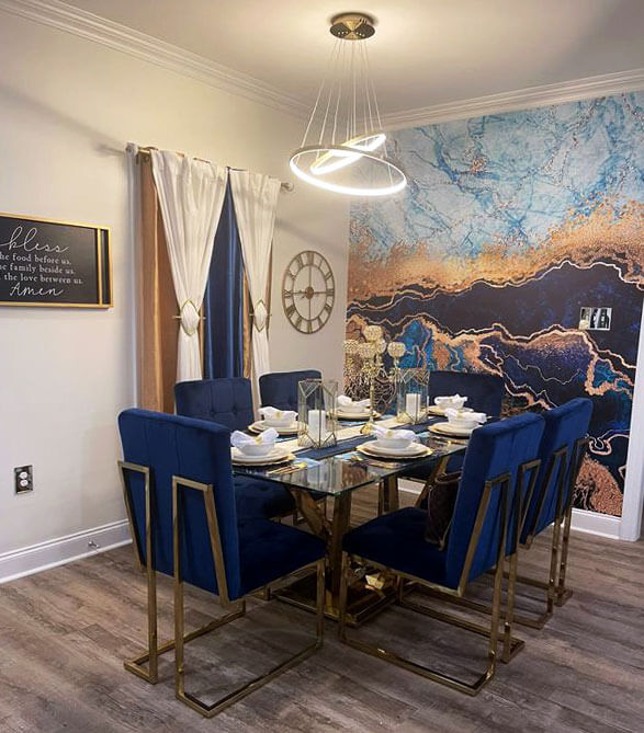 Blue and gold themed dining room with a blue and gold marble wall mural and blue dining chairs
