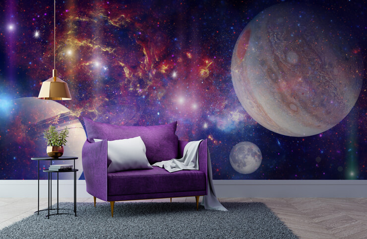 Space wallpaper with purple and blue swirls and stars with large planets in a living room with a purple chair and white wood flooring