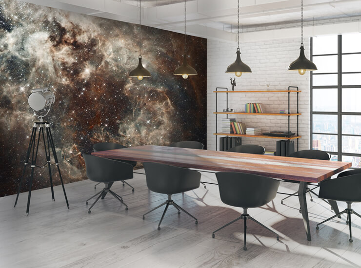 Brown and beige space wallpaper of a nebula in a boardroom with a large wooden table and black office chairs