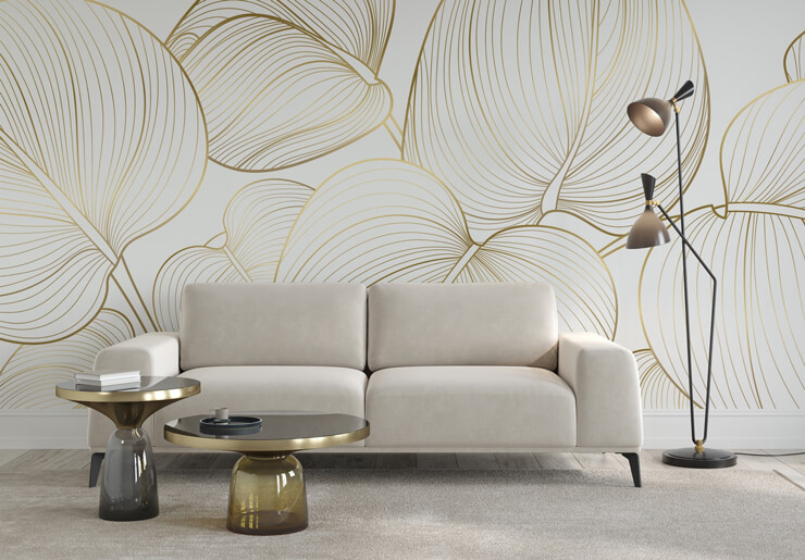 Neutral gold effect wallpaper with a leaf design in a neutral living room with a cream sofa and rug