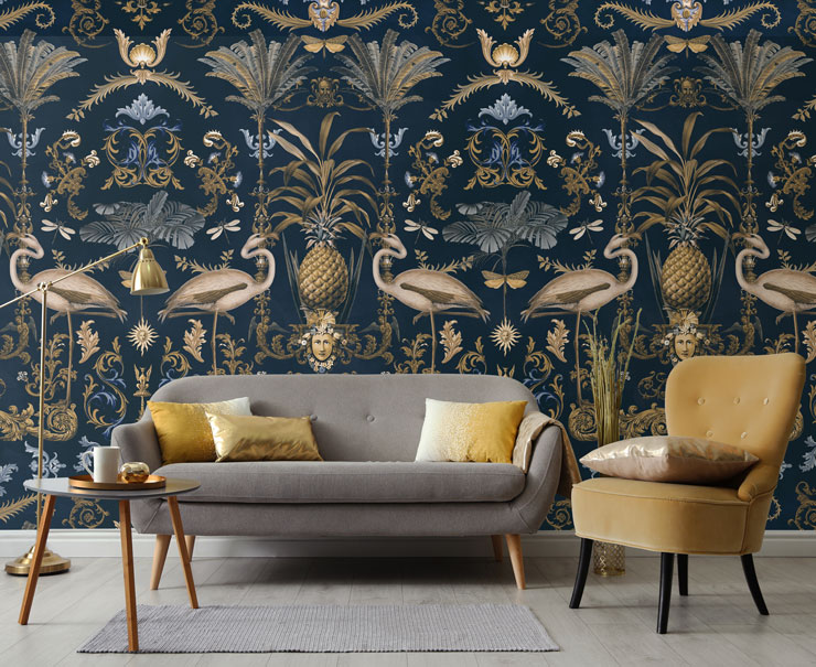 Navy and gold wallpaper with an elegant flamingo design in a living room with gold and grey chairs