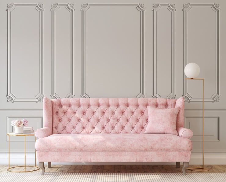 Classic cream wood effect panel wallpaper with a blush pink sofa