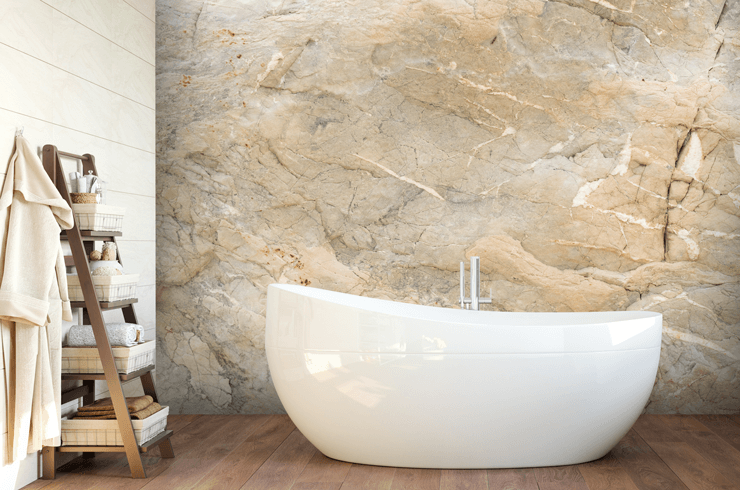 Natural marble effect wallpaper in a neutral spa bathroom with a free standing bath