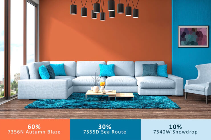 Orange and blue living room walls with a large grey sofa and black hanging pendant lights