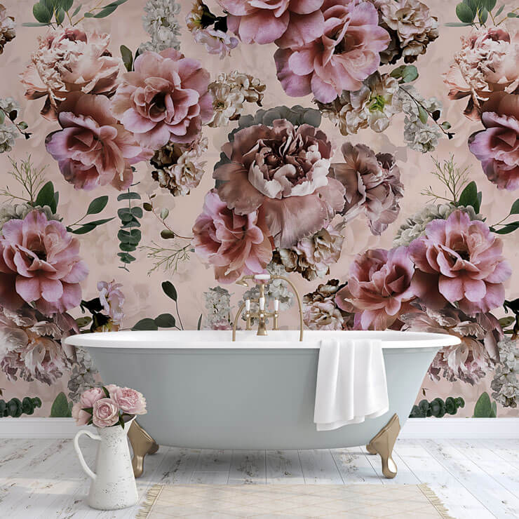 Romantic bathroom with a blue bath a pink floral wallpaper