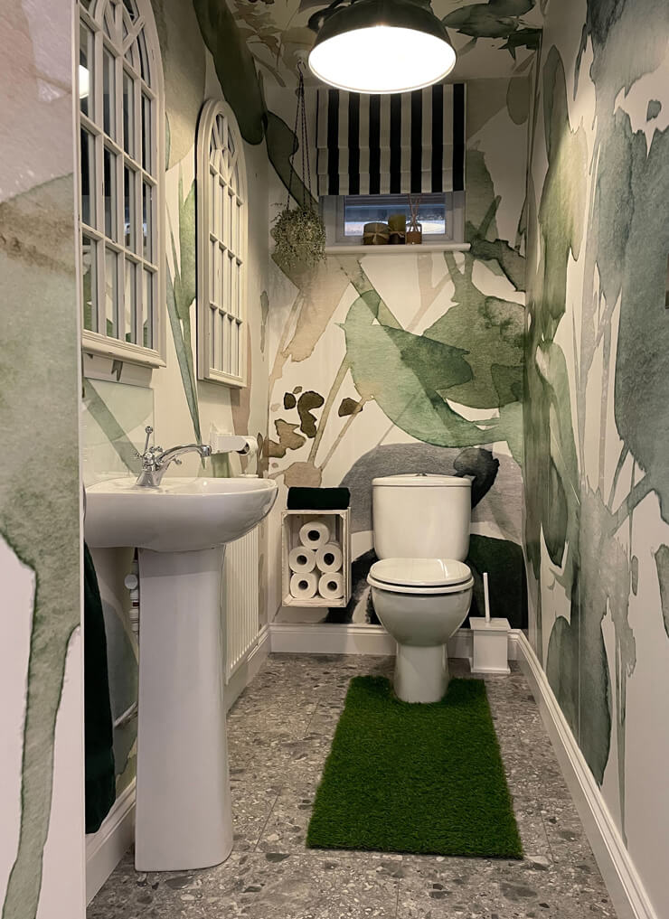 Bold maximalist bathroom with green wallpaper
