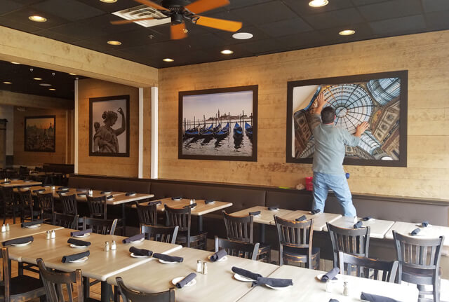 restaurant owner installing murals