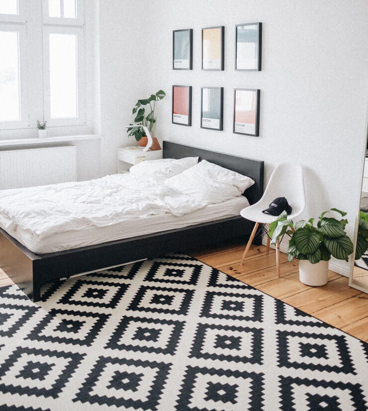 large rug in small bedroom