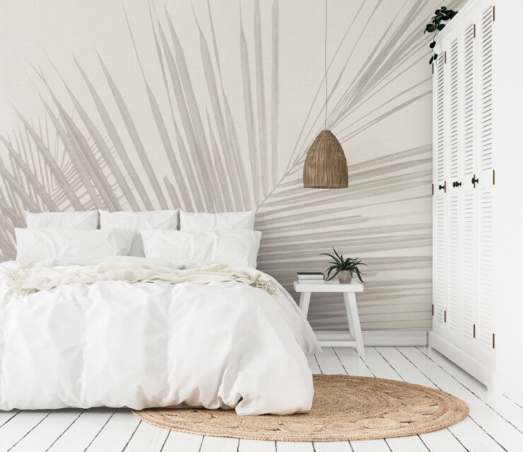 tropical palm leaves neutral wallpaper mural in a bedroom