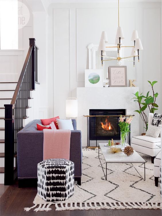 lounge by stairs in white room with colourful accessories