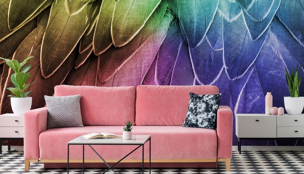 multicoloured wallpaper in living room with pink sofa