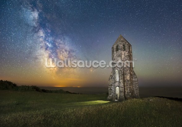 medieval lighthouse next to the milky way