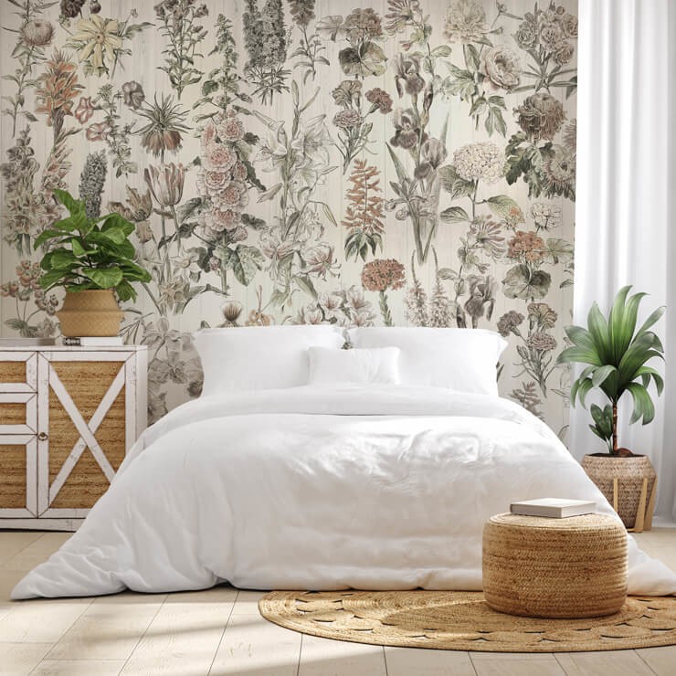 Meadow inspired wallpaper mural with a white bed and wicker furniture