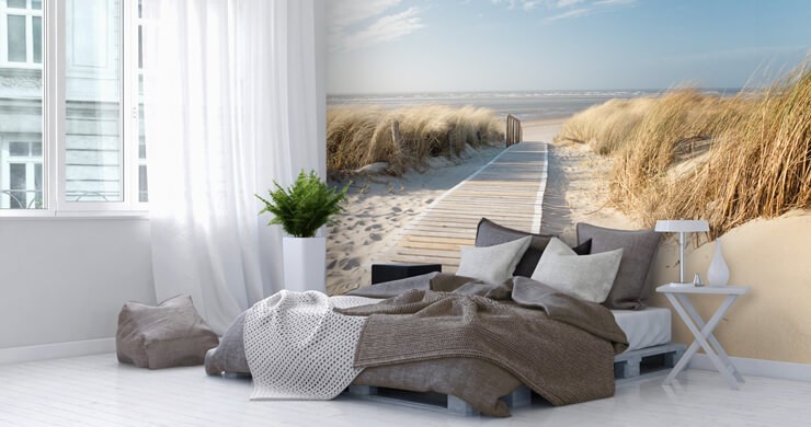 Neutral coastal grandaughter inspired bedroom with white bed sheets and a beach wall mural