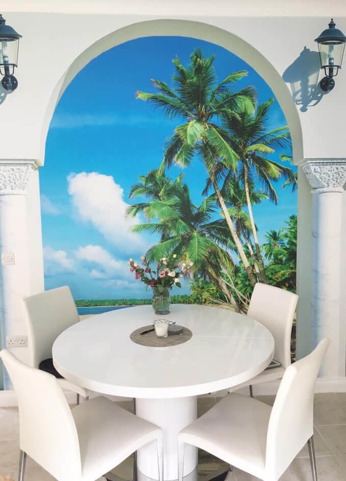 3D effect white arch showing beach wallpaper in white dining room