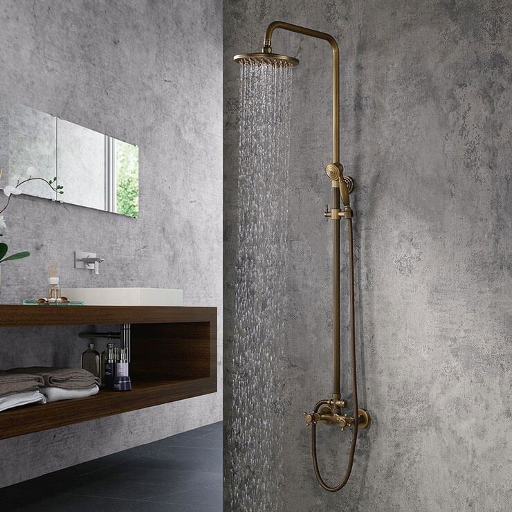 gold shower head in grey bathroom