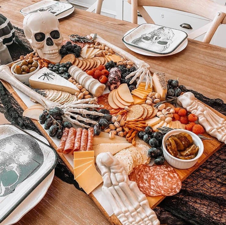Charcuterie board with meat, cheese and crackers held together by a skeleton