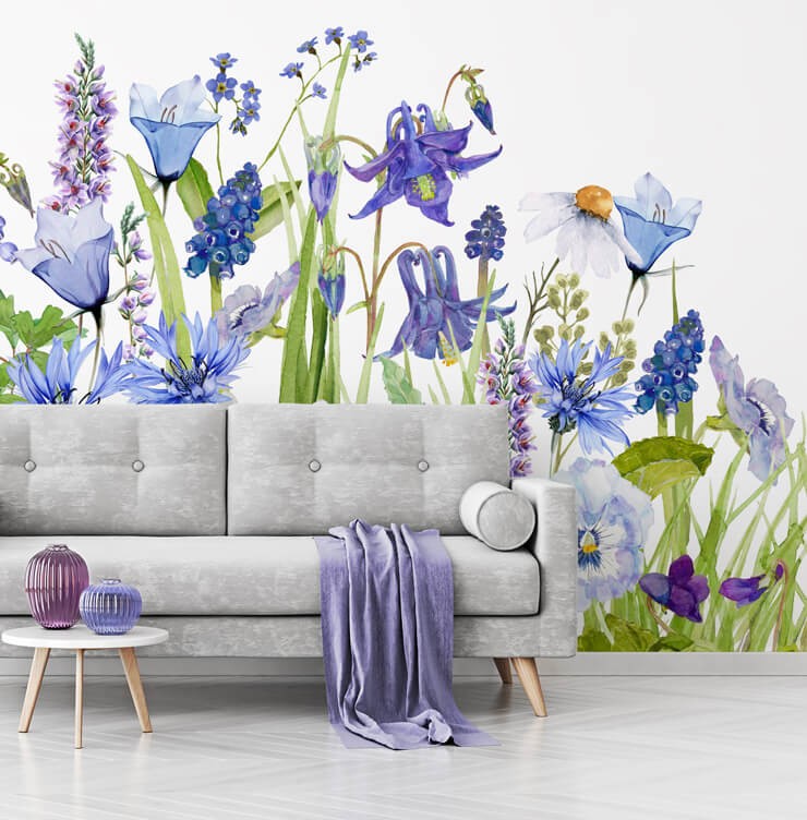 purple flowers wallpaper with grey couch and purple accessories