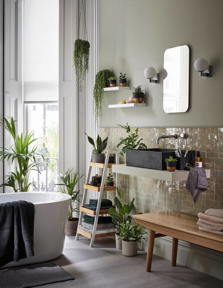 bathroom adorned in tropical plants showing how to decorate with plants in a dark bathroom
