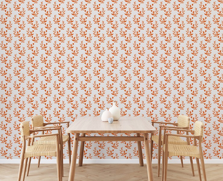 orange and white leaf wallpaper with wood and wicker dining table and chairs