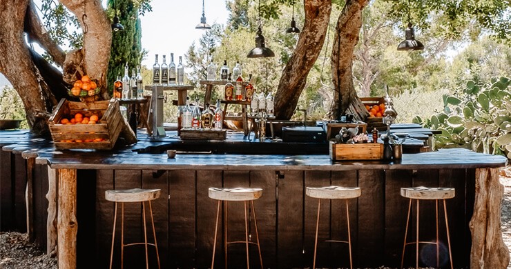 outside bar under trees with stools