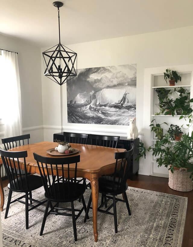wooden dining table and black chairs in dining room