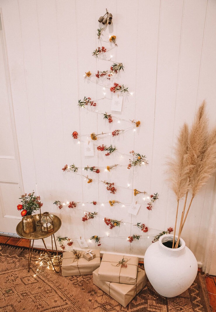 Christmas trees for small spaces made from white lights and berries and leaves in a cream room