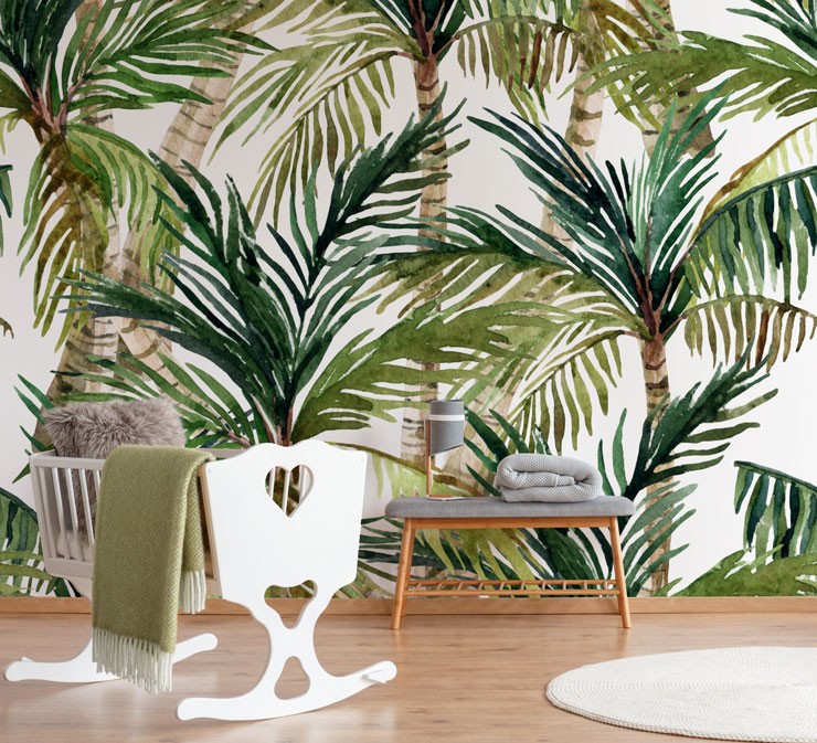 palm tree wallpaper behind cot in nursery