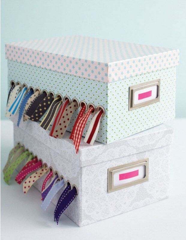 Colourful pastel boxes with holes holding multi coloured ribbons