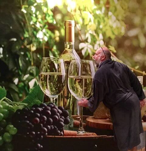 wine glasses, grapes and cheese wallpaper with customer pretending to drink wine