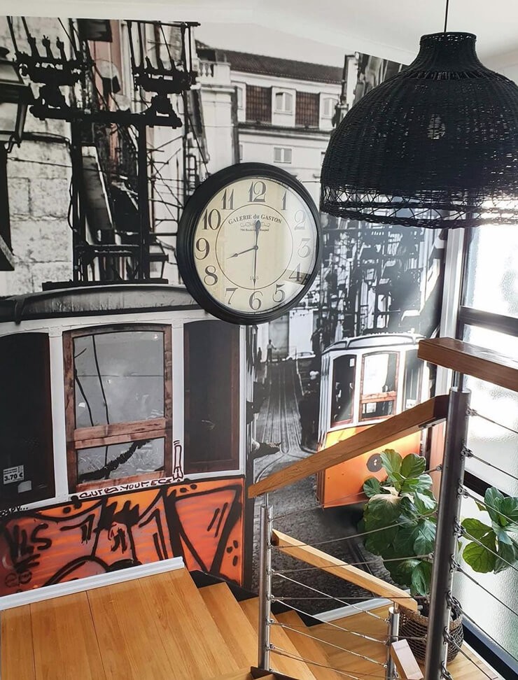 graffiti style wallpaper next to metal and wood staircase