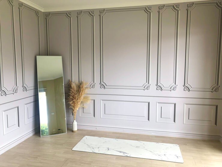 creamy grey panel wallpaper in room with mirror and fitness mat