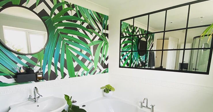 monochrome bathroom with green palm wallpaper
