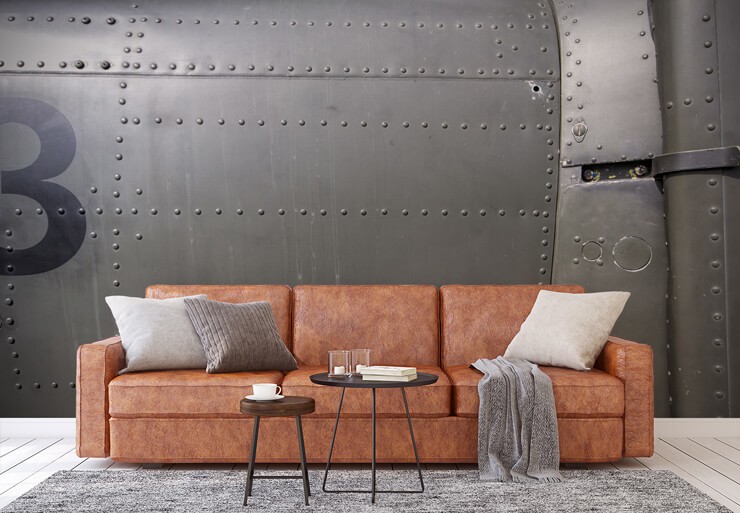 metal door wallpaper in living room with leather couch