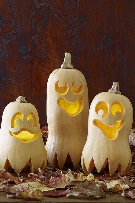 Three white, long carved pumpkins to look like ghosts
